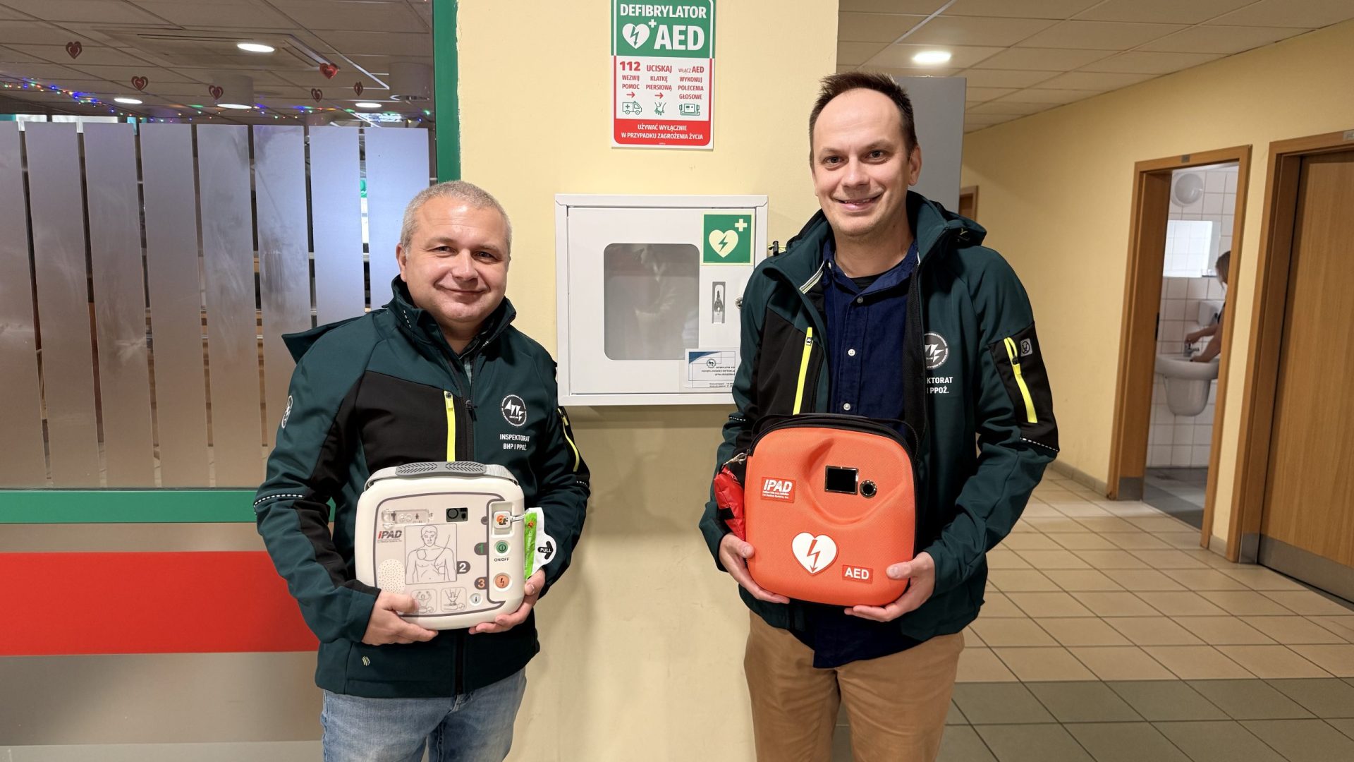 dwaj mężczyźni z pudełkami w dłoniach jedno jest białe, drugie pomarańczowe