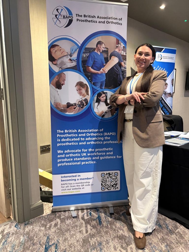 kobieta pozuje na tle reklamy konferencji